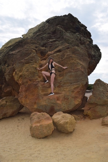 Amateur model gets naked in high-heeled footwear on iron ladened rocks