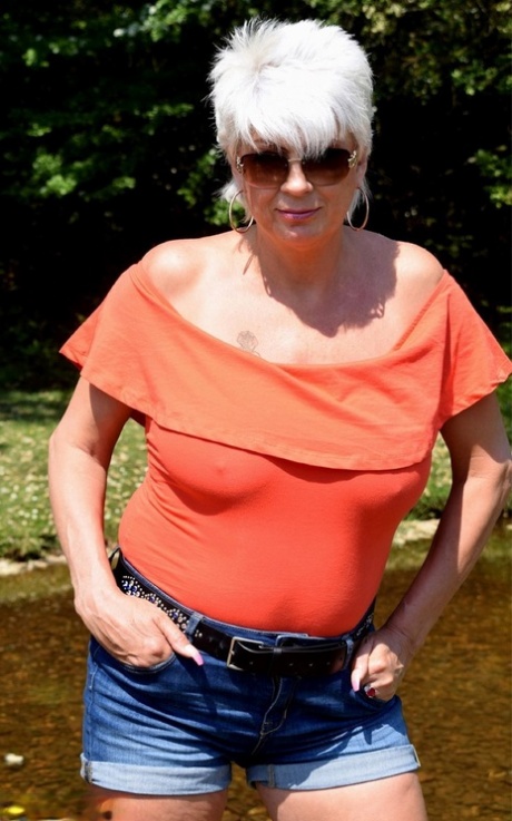 Ältere Amateurin Dimonty entblößt ihre natürlichen Titten am Ufer eines Baches