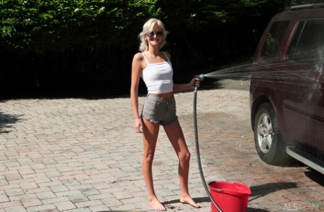 Platinum blonde teen Tallie Lorain gets totally naked while washing a vehicle