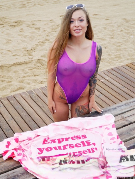 Solo girl Misha Maver changes into a swimsuit while on a boardwalk