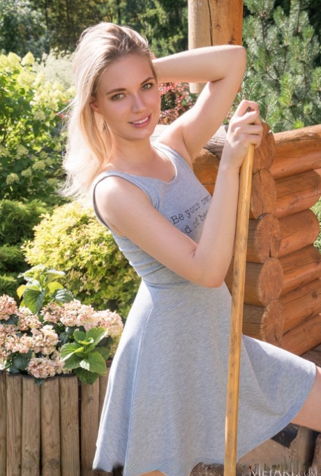 Young blonde Maxine puts her tight slit on display after sweeping a walkway