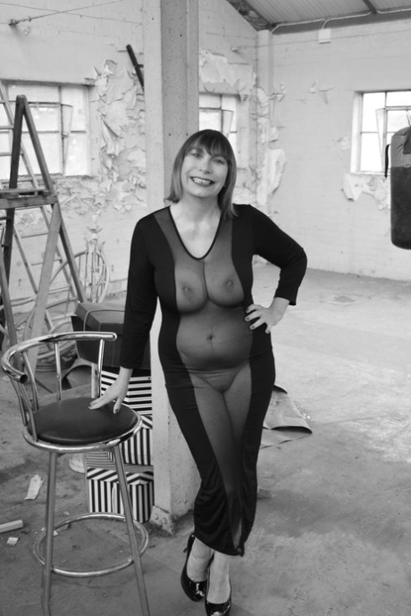 Middle-aged woman Barby Slut models a see-thru dress for a black-and-white gig