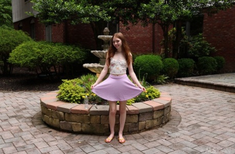 Charming teen Myra Glasford gets totally naked in front of a garden fountain