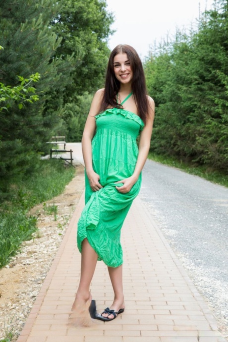 Sweet teen Evita Lima sets her great body free of a long dress on a sidewalk