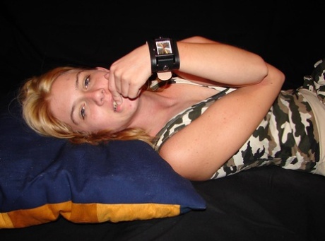 Blonde amateur Gina admires her Axcent watch during a non-nude gig