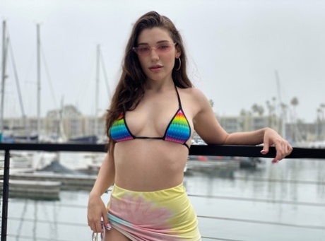 Brunette chick Lily Lou models a bikini at a marina before rough sex inside