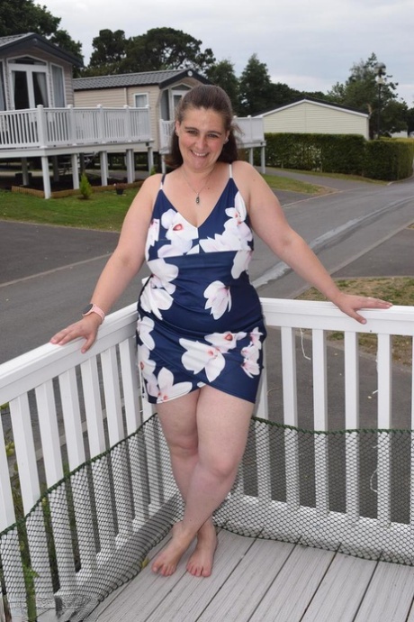 Middle-aged fatty exposes herself on a balcony in a public location