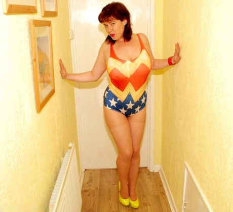 Middle-aged UK woman Juicey Janey models a swimsuit in high-heeled shoes