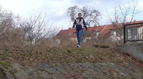 Caucasian girl Antonia Sainz scrambles down a bank for an urgent piss