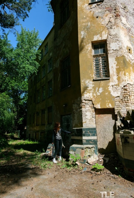 Tattooed redhead Cherr plays with her horny pussy at a derelict building