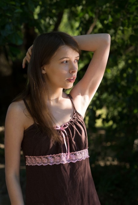 Sweet teen Jemma A gets completely naked in a treed location