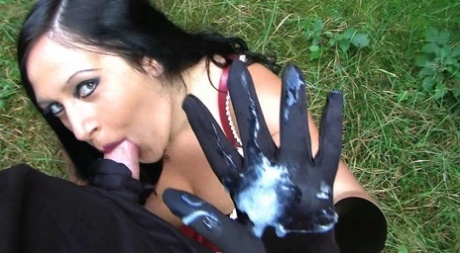 Goth woman Lady Angelina sucks the sperm from a big cock near the woods