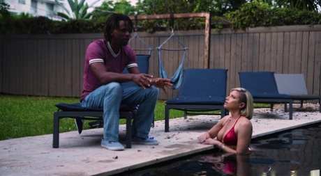 Blonde girl Kaylynn Keys emerges from a swimming pool before interracial sex