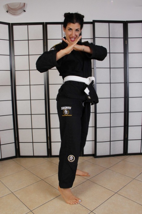 Hot brunette Bianca Blance shows her pretty feet in martial arts clothing