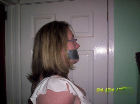 Caucasian female shows her natural tits while gagged and rope bound