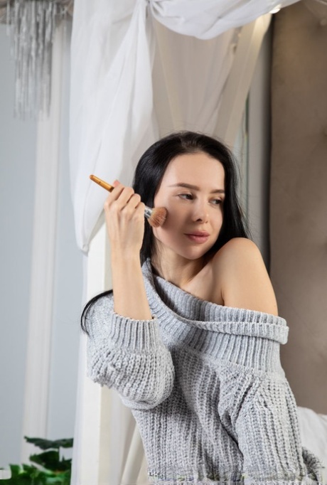 Dark haired teen Lili Eris removes a sweater dress and thong to pose naked
