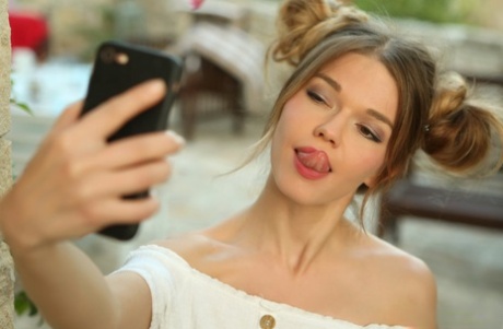 La superbe Nedda se lèche les lèvres en prenant un selfie avec des boules de neige.