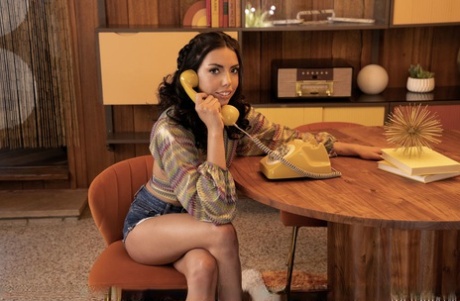 Hot brunette Rachel Rivers strips her heels after talking on a retro telephone