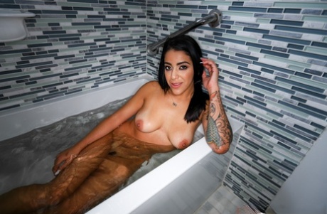 Tattooed brunette Mia Martinez relaxes in a bathtub before POV sex