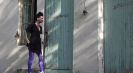 Flexible brunette Gypsy Queen takes a piss outside of an abandoned building