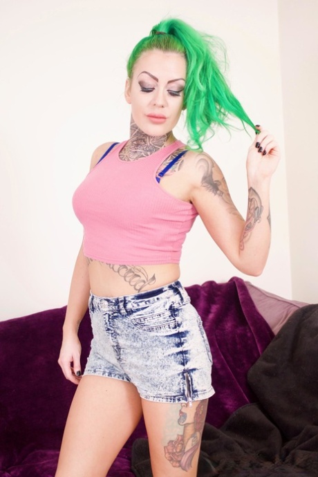 Tattooed girl with dyed hair Phoenix Madina teases her man friend before sex