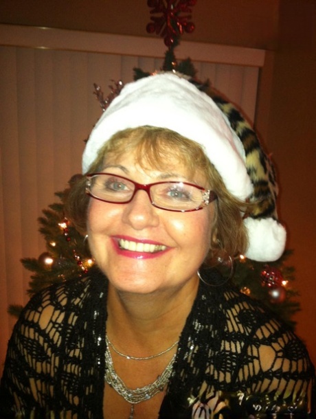 Oudere vrouw Busty Bliss onthult haar natuurlijke tieten voordat ze een lul likt met Kerstmis