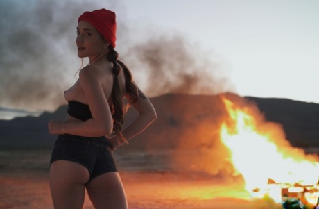 Sera Ryder plays with her pigtails near a bonfire before having sex