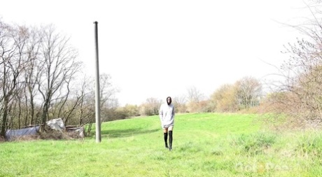 Brunette MILF Ali Bordeaux takes a badly needed pee outside a locked outhouse