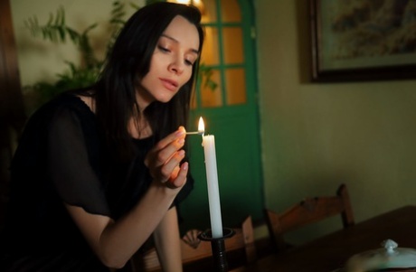 Brunette teen Adel Morel lights a candle before masturbating in the nude