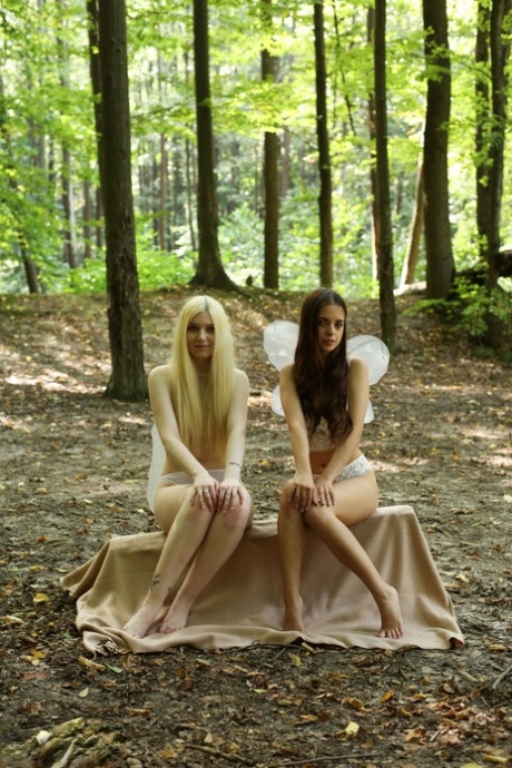 Beautiful young girls Tata & Suna pose in the woods while wearing fairy wings