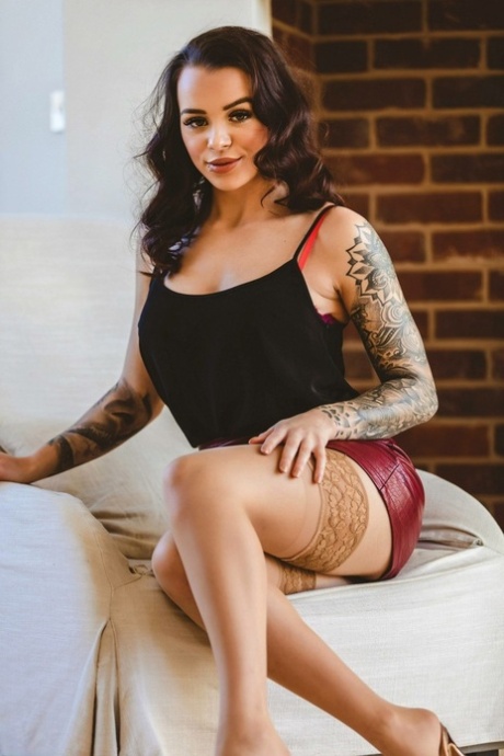 Den tatoverte brunetten Mia Stryker er naken iført strømper og høye hæler.