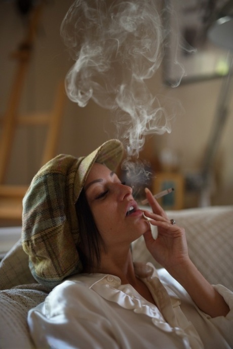 British brunette Cassie Clarke lights up a cigarette during non-nude action