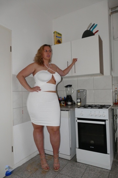 Kathy D, femme mûre, joue avec ses gros seins avant de faire l'amour dans une cuisine