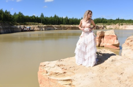 Blonde girl Ava List steps into the water after getting completely naked