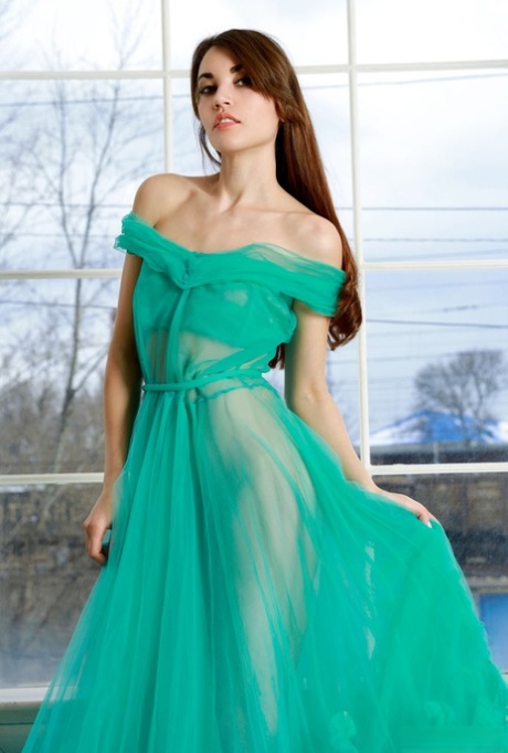 Sweet brunette teen Rosie Lauren discards an elegant gown to model naked