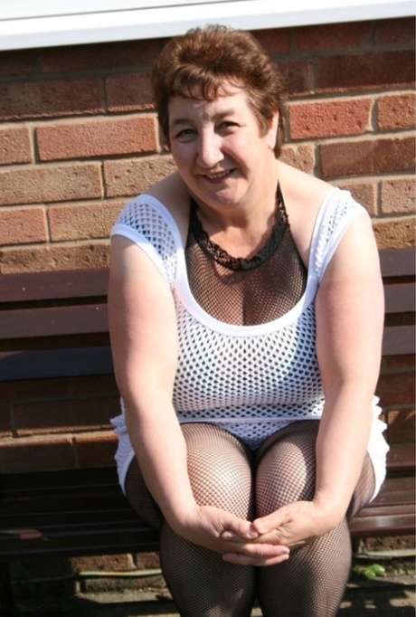 Mature fatty Kinky Carol goes nude outside her home in crotchless hosiery