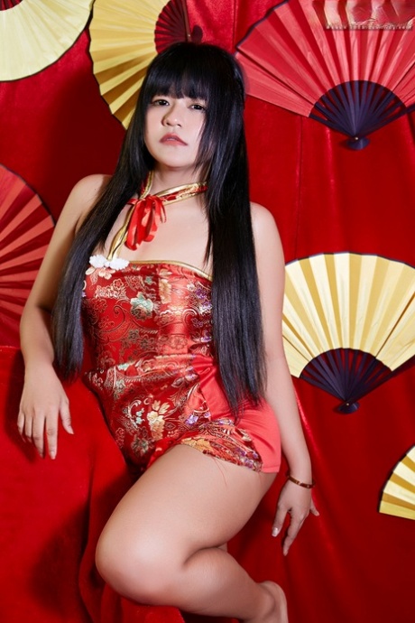 Chubby Asian girl Dorothy slips a sex toy inside her hairless vagina