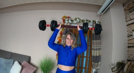 Middle-aged blonde Sweet Susi gets naked while pumping iron at home