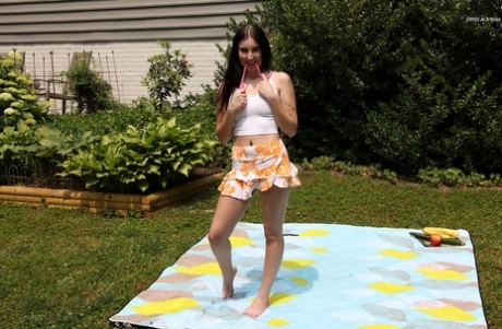 Brunette teen Briston Moreau masturbates with a cucumber and banana in a yard