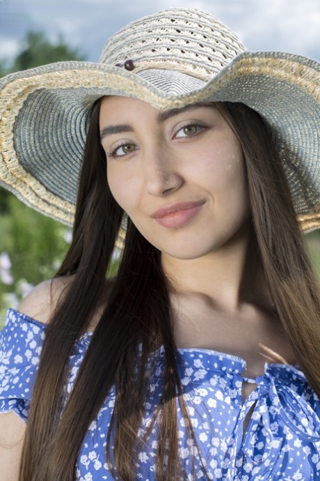 Young brunette Bella unveils her great body on a folding chair in a field