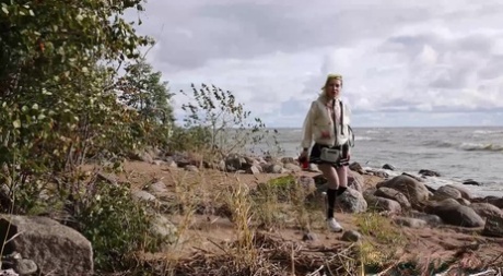 Blonde girl Squanch Baby pees on the beach while out for a stroll