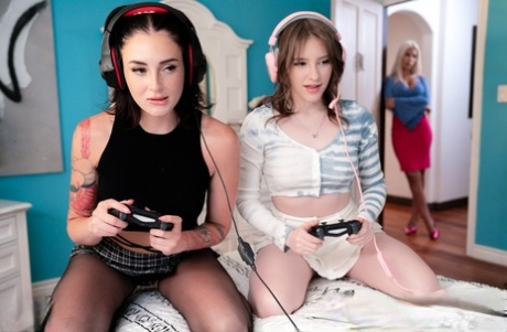 Stepsisters play video games before a lesbian threesome with their stepmom