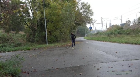 Caucasian girl Barbe takes a badly needed piss on wet pavement