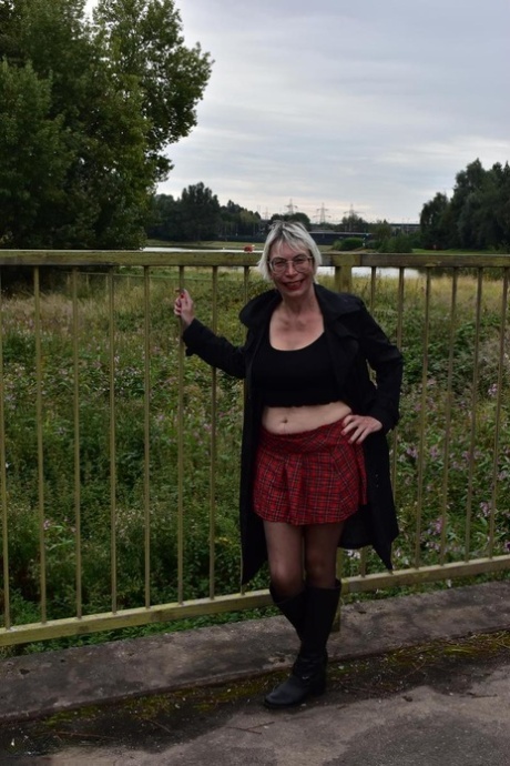 Den britiske kvinde Barby Slut viser sine store bryster og fisse på en offentlig bænk
