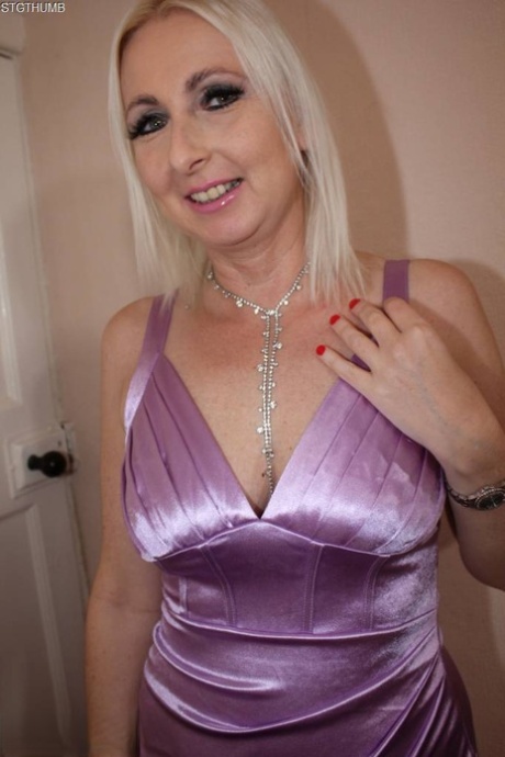 Blonde British lady Tracey Lain poses in a dress before having POV sex