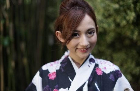 Japanese girl Reon Otowa frees her trimmed bush from a kimono while outdoors