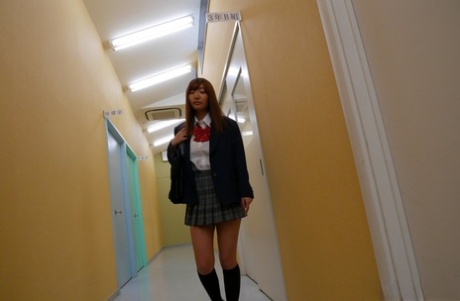 Redheaded Japanese student Misaki Asuka masturbates with a toy in a bathroom