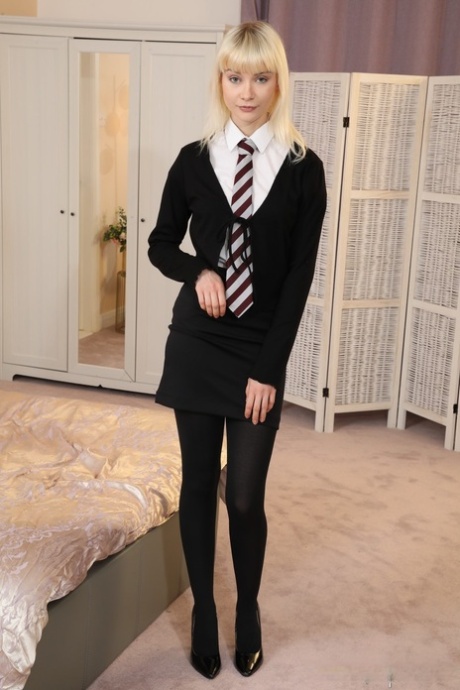 Jessica Louise de Only Opaques en uniforme universitaire avec des talons hauts et des chaussures de sport.