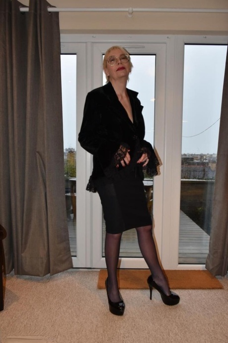 Older British lady Barby Slut strips to a garter belt and nylons in high heels