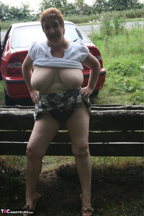 British fatty Kinky Carol shows her huge tits and snatch in the countryside